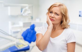 Woman with a dental pain in a dental office.