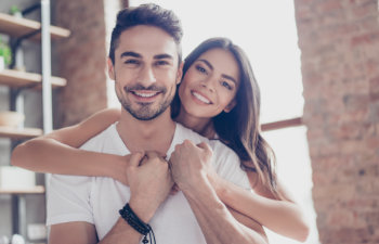couple smiling in love at home